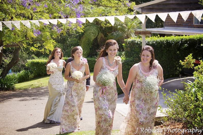 Bridesmaids heading down aisle in garden wedding - wedding photography sydney